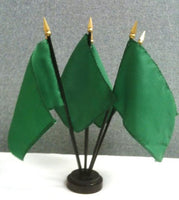five hole black plastic flag stand with five green flags inside